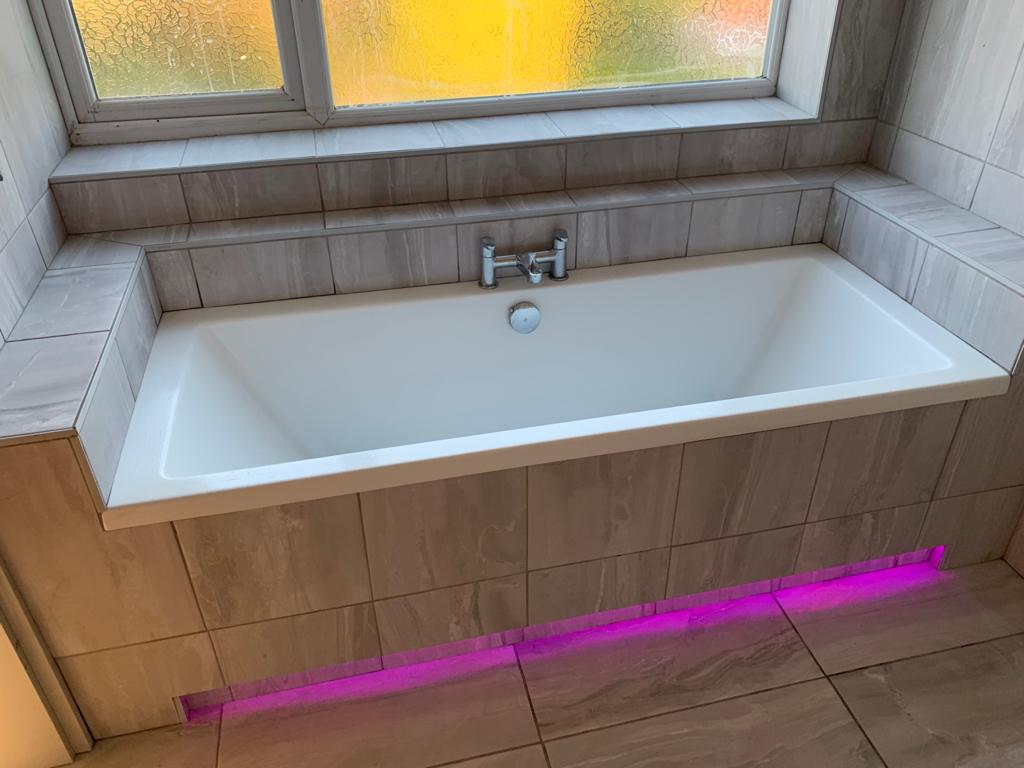 white-bathtub-tiled-surround-pink-led-strip