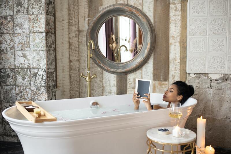 woman-in-freestanding-bathtub-brass-tap-candles